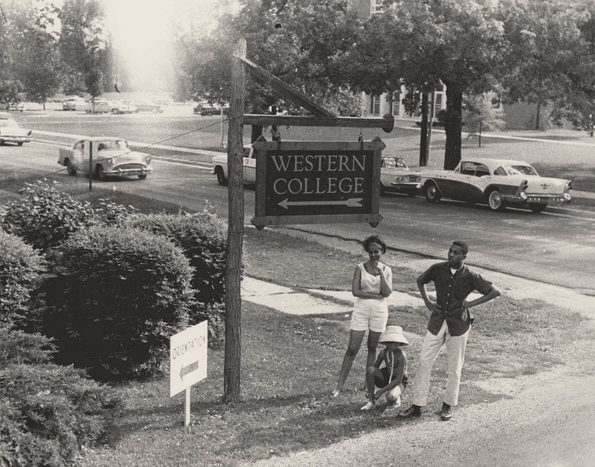 Western College Sign with Three Young People, June 1964. Photograph by Herbert Randall.